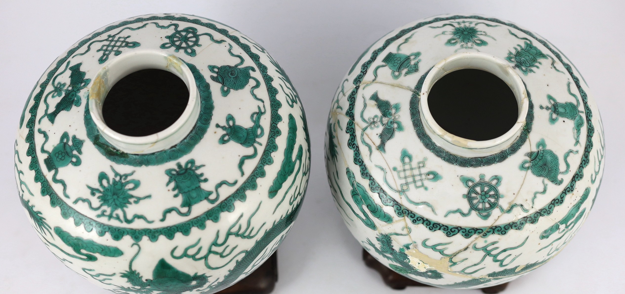 Two similar Chinese green enamelled ‘dragon’ jars and covers, Daoguang mark and period (1821-50), 21.5cm high, damaged and repaired